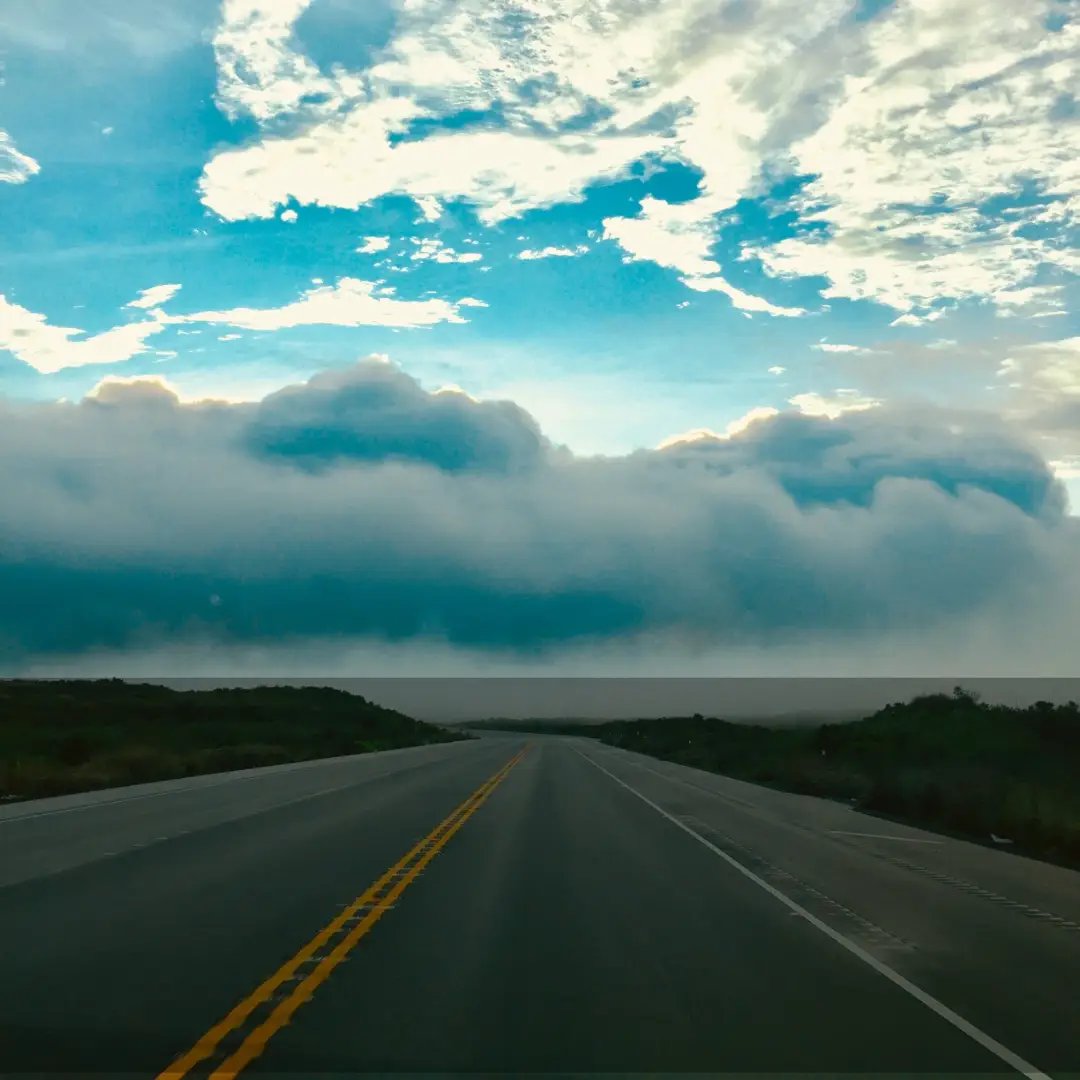 Saddle Road on Hawaiʻi Island cutting through high elevation lava plains beneath low clouds