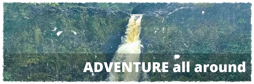 Waterfall in lush rainforest on Big Island Hawaii volcano and waterfall tour