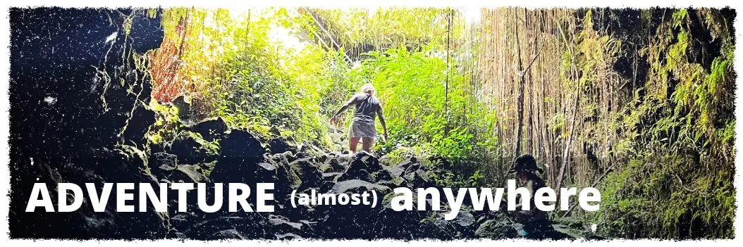 Guest exploring a jungle lava tube and rainforest terrain during a custom Big Island private tour
