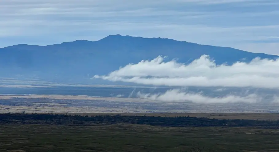 Hualālai Volcano viewed from Saddle Road, with clouds drifting across the high desert of the Big Island.