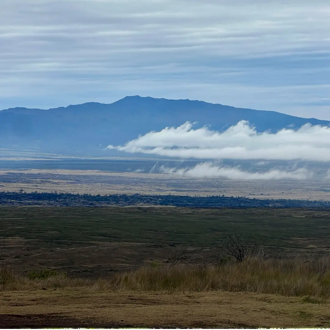 Hualālai Volcano viewed from Saddle Road, with clouds drifting across the high desert of the Big Island.