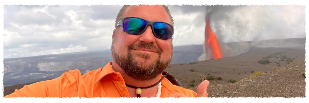 Meet Scott, private Big Island volcano tour guide, standing near an active lava eruption at Hawaiʻi Volcanoes National Park
