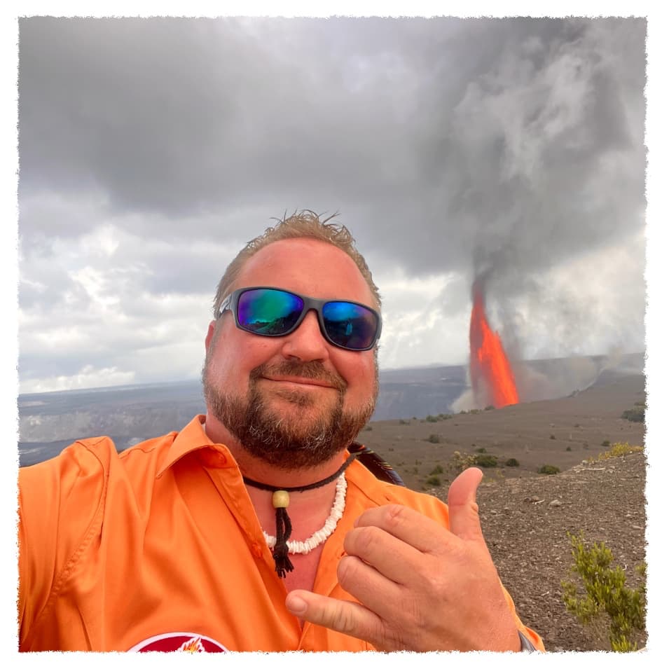 Meet Scott, private Big Island volcano tour guide, standing near an active lava eruption at Hawaiʻi Volcanoes National Park